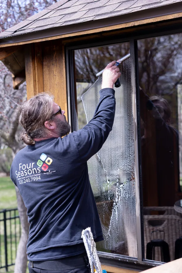 Matt Bertsch squeegeeing a residential window exterior