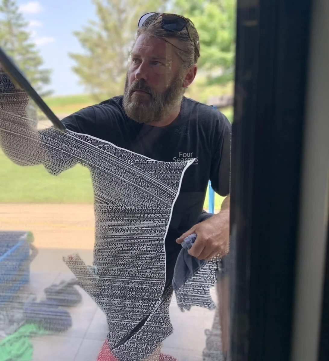 Matt Bertsch cleaning a residential window